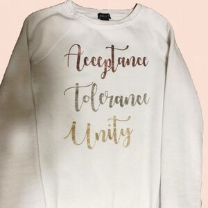 Cream sweater with metallic graphic print “Acceptance Tolerance Unity”